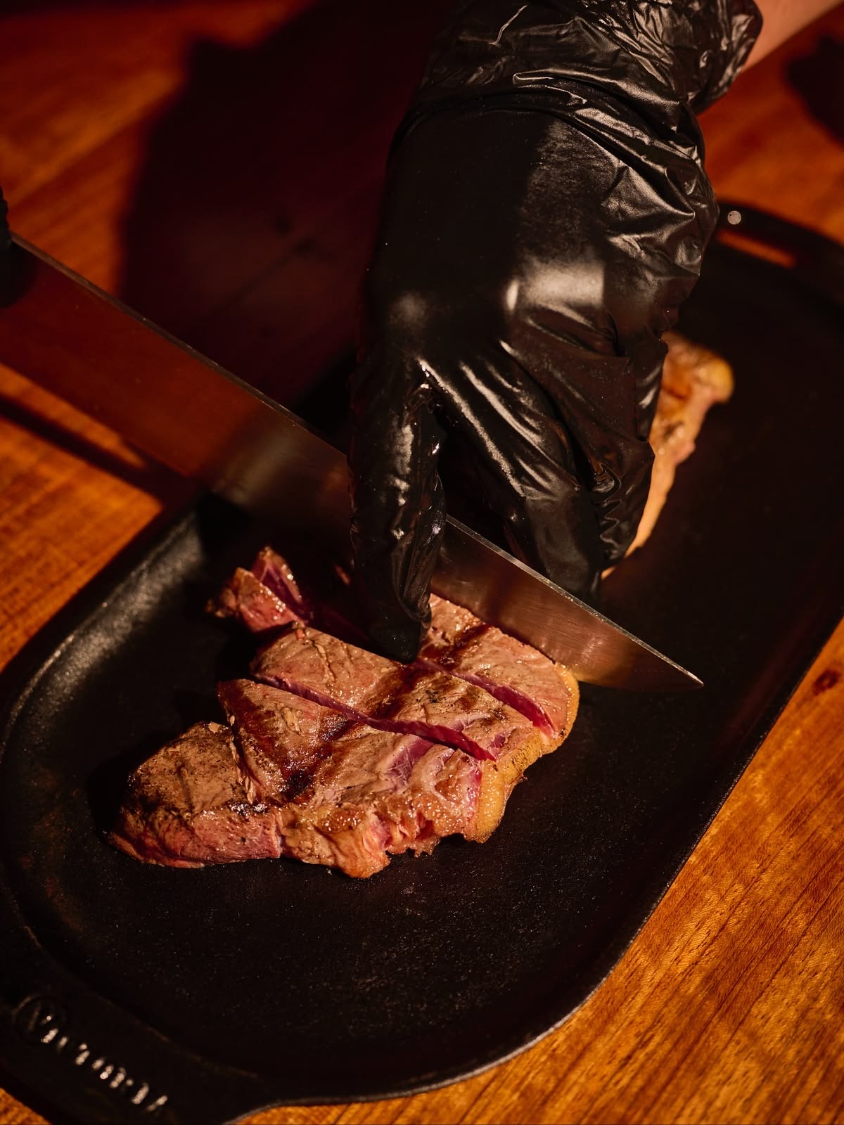 Chef slicing a rested steak